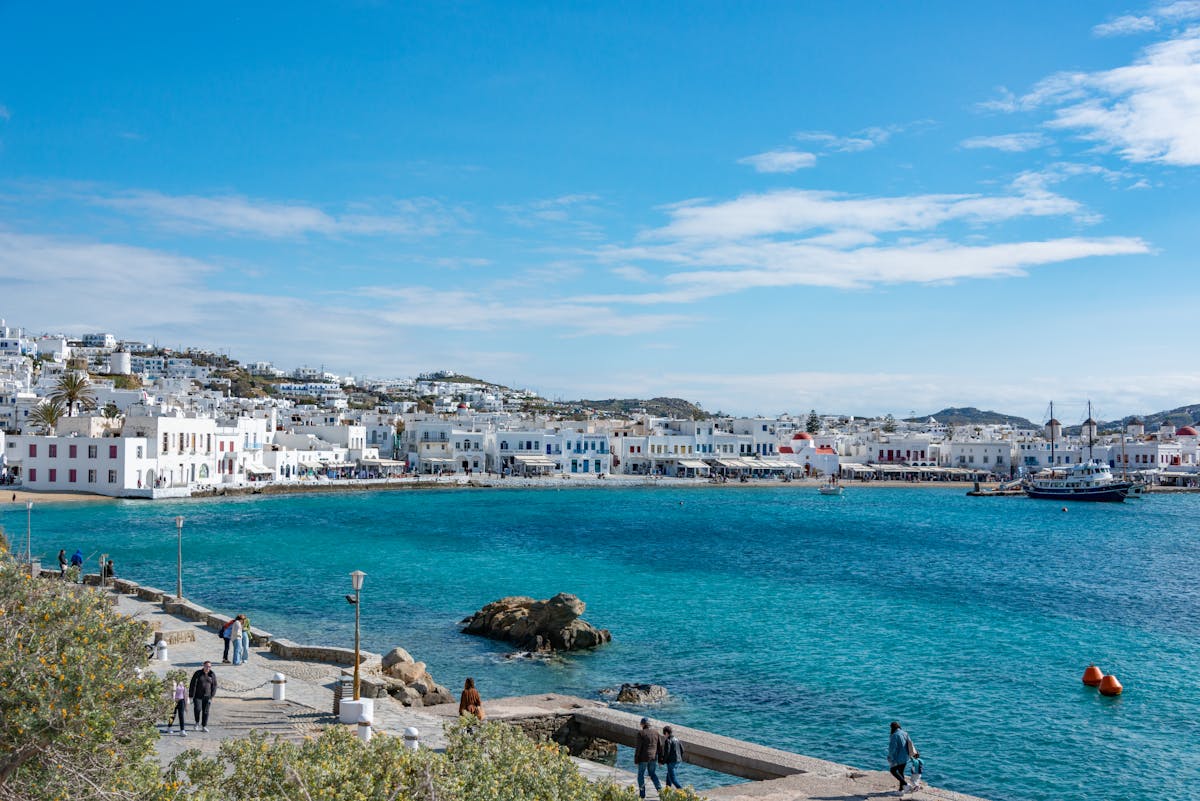 Mykonos town waterfront with visitors strolling along the seafront