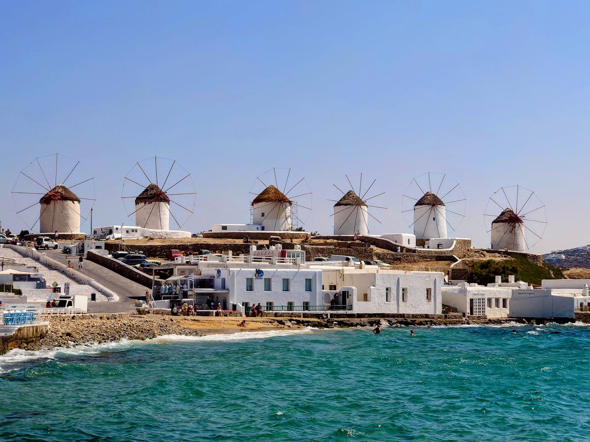 Historic windmills of Mykonos overlooking the bright Aegean Sea