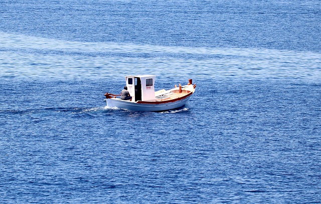 Traditional fishing boat on calm waters near a Greek island