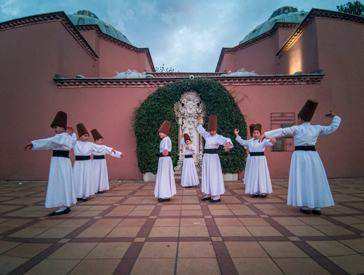 Whirling dervishes performing in a courtyard setting