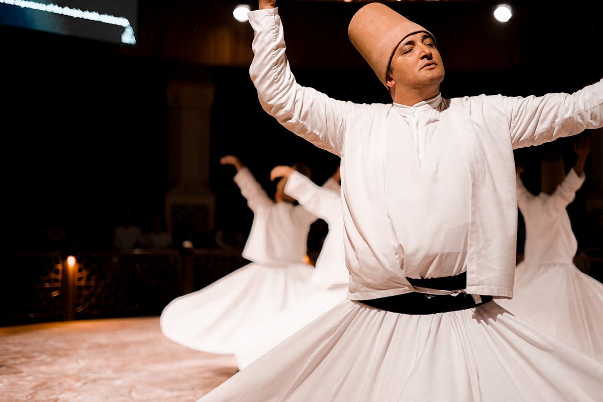 A Sufi dervish spinning in traditional white robes