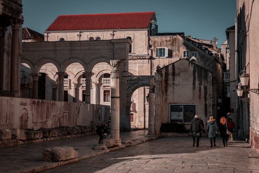 Ancient stone alley with people walking Split Croatia