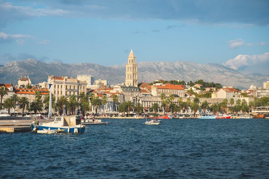 Split old town waterfront view with mountains
