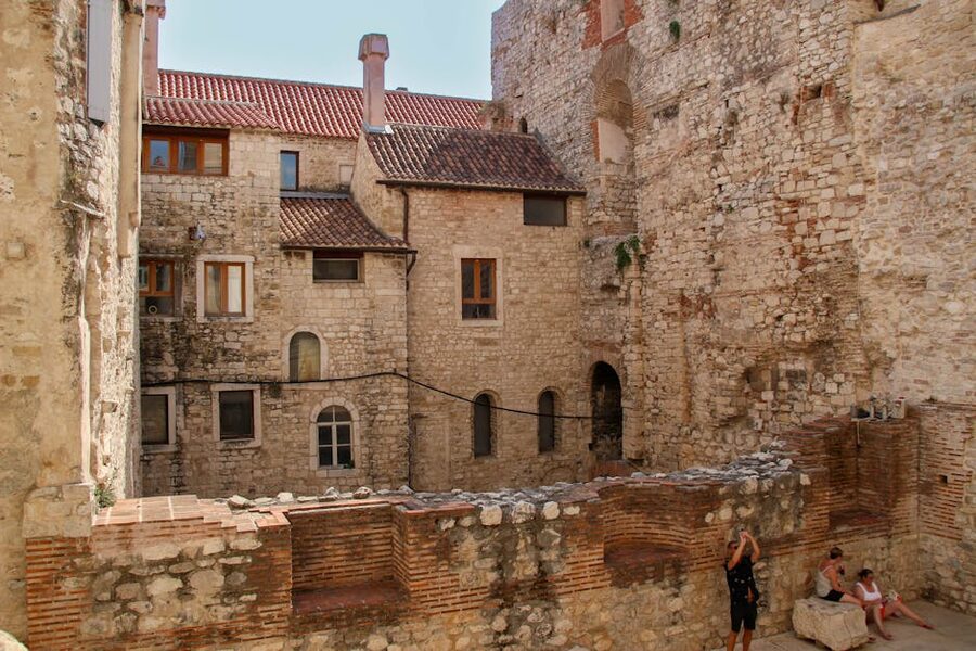 People in ancient stone courtyard Split Croatia