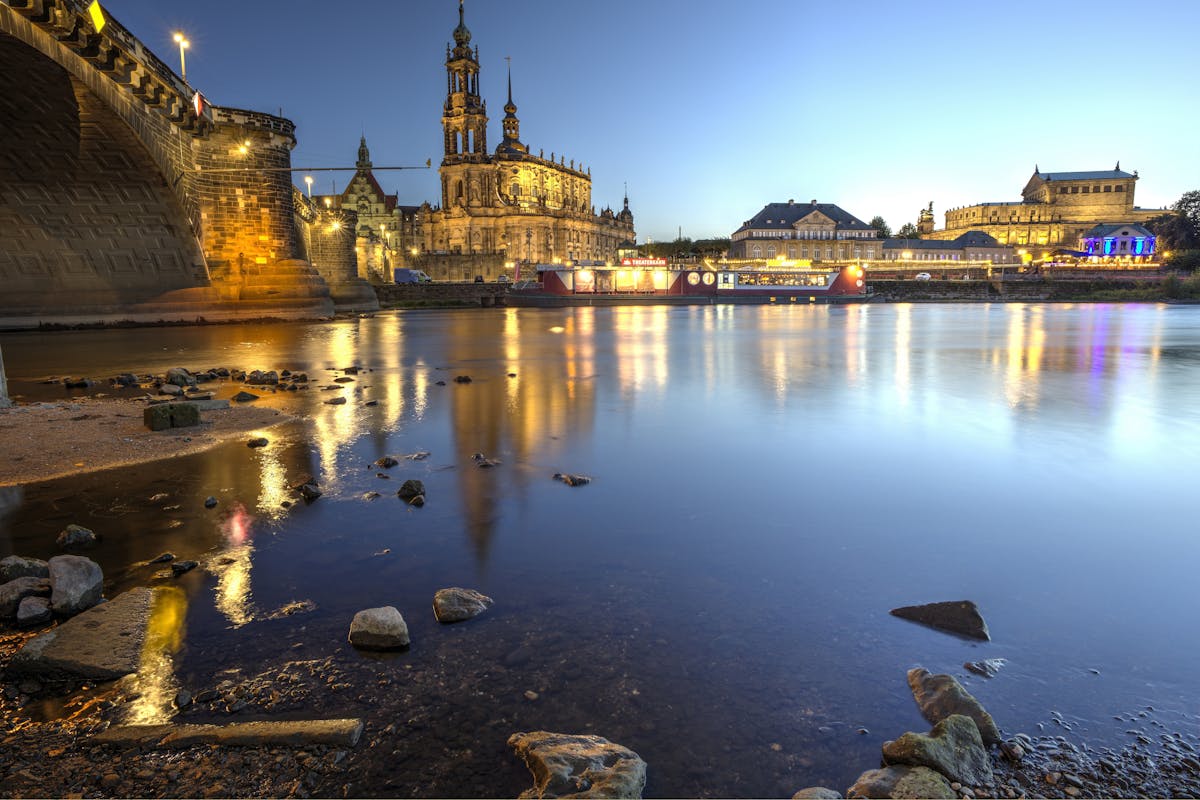 Dresden historic skyline with churches and bridges reflected in the Elbe River during blue hour