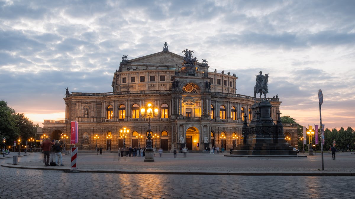Semperoper Dresden opera house and equestrian statue of King Johann at dusk
