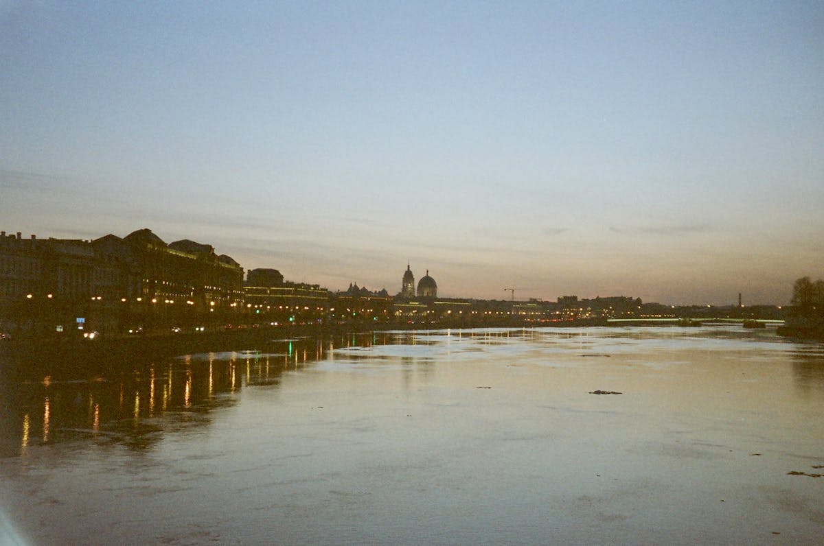 Dresden city skyline at sunset with buildings reflected in the Elbe River