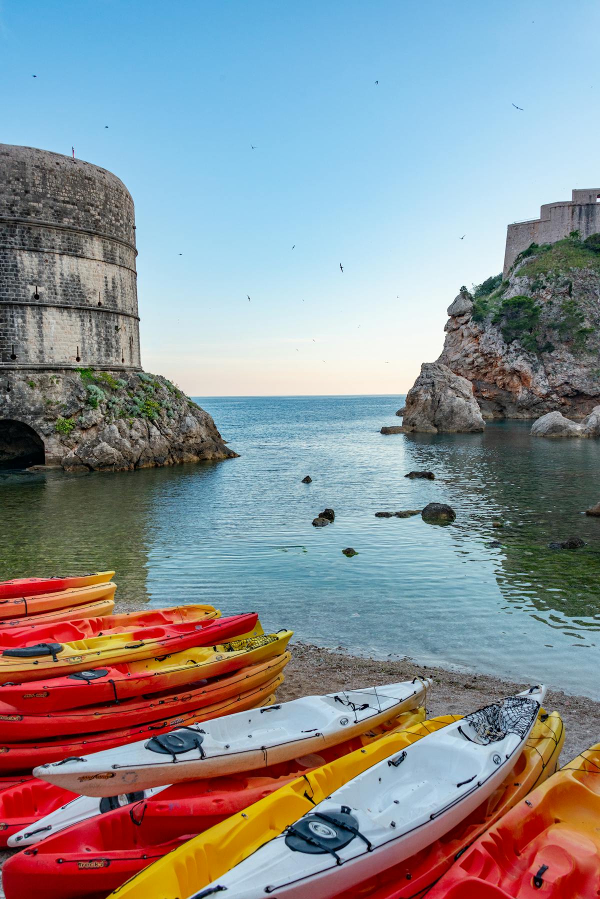 Colourful kayaks by Dubrovnik fort on the Adriatic coast