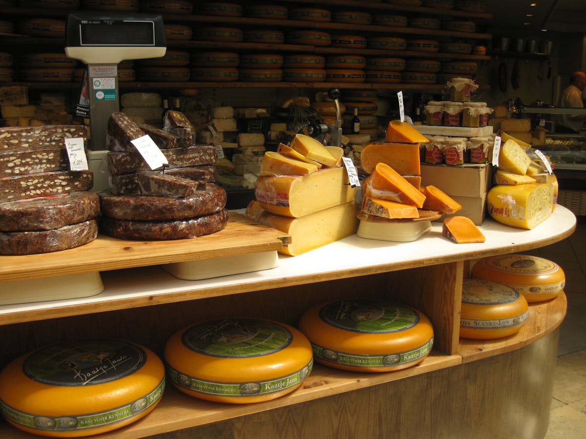 Dutch cheese varieties stacked on shelves in a traditional shop
