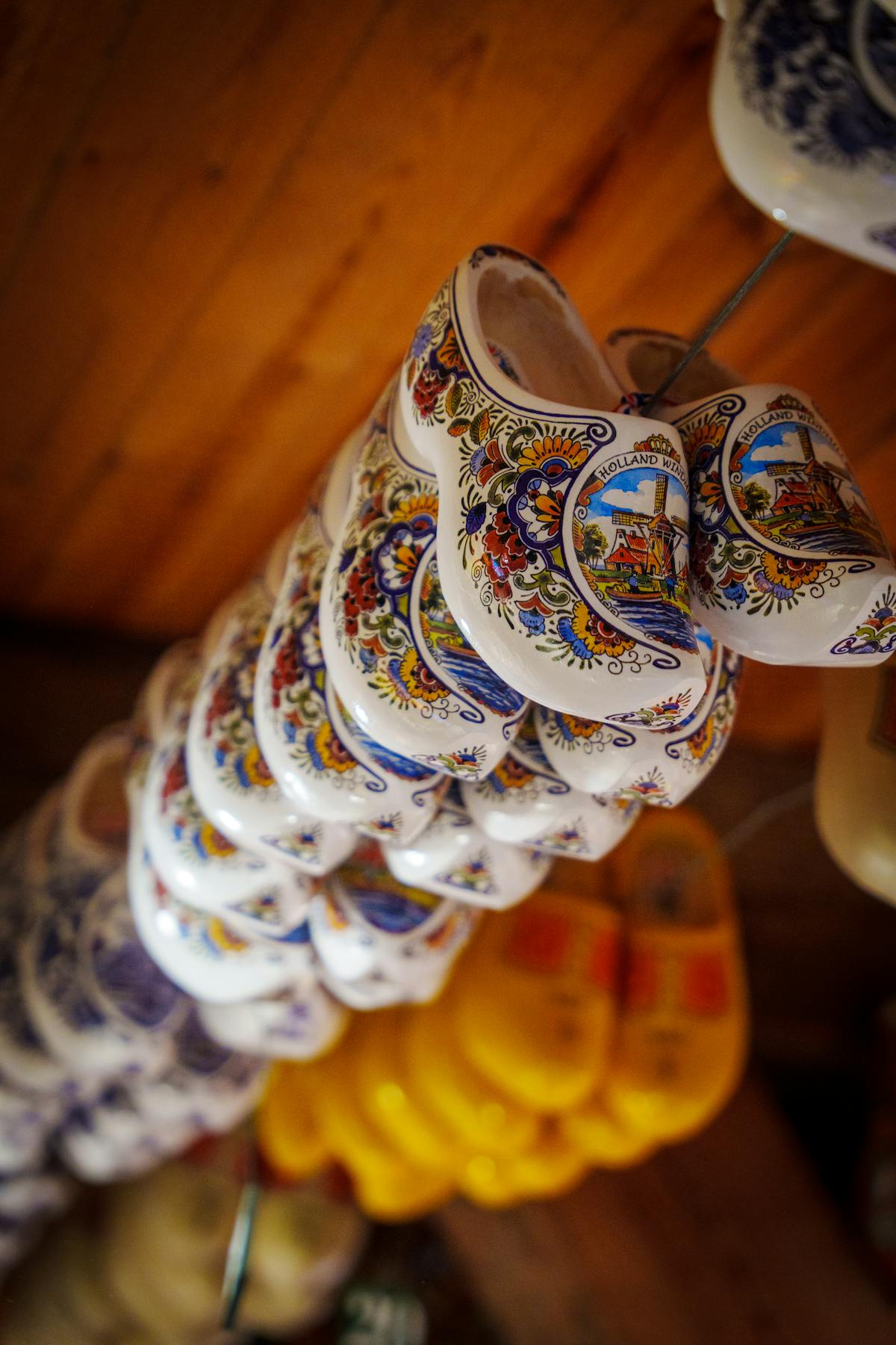 Hand-painted Dutch clogs hanging in a traditional workshop