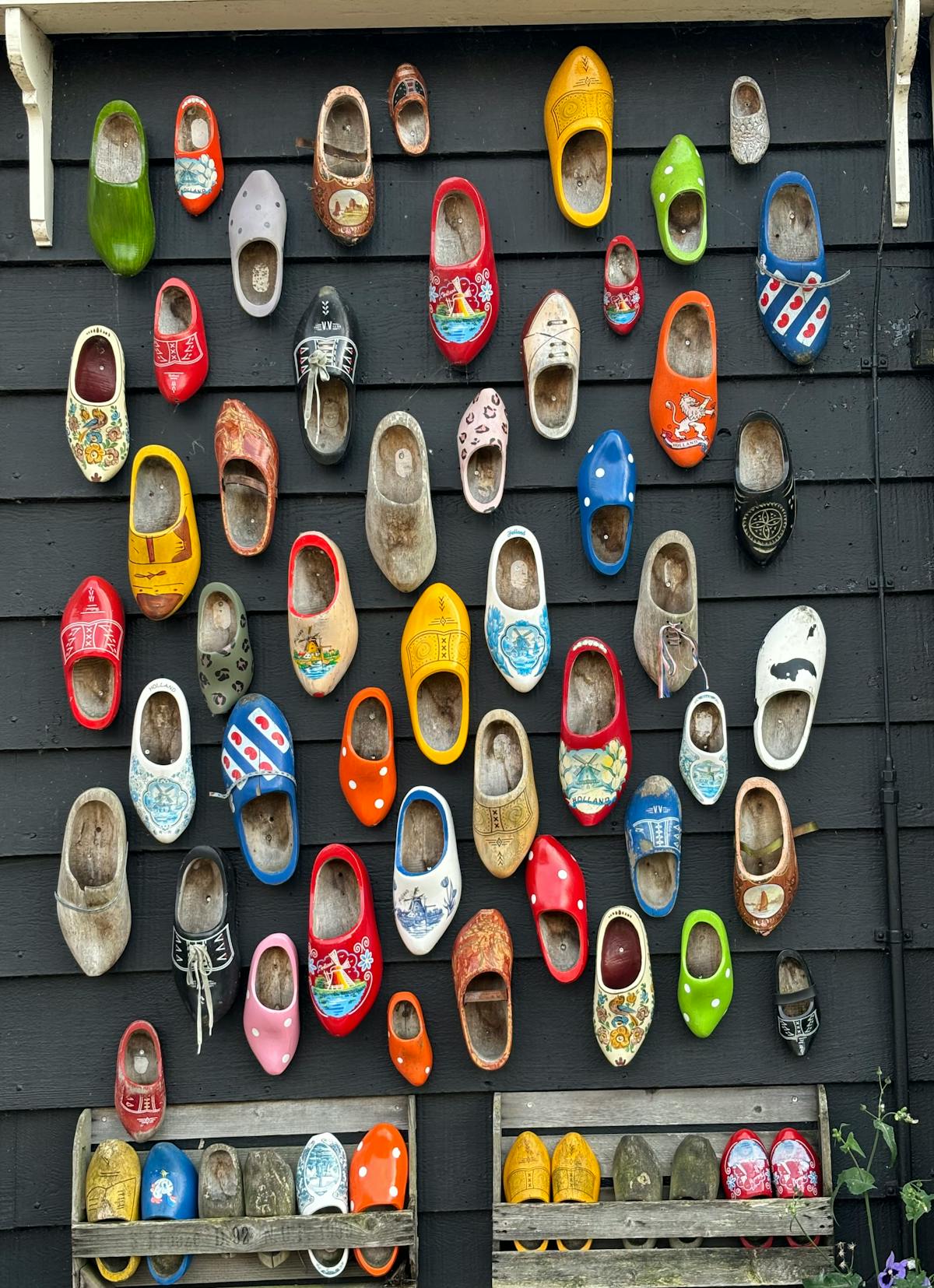 Colorful wooden clogs displayed on a wall in Zaandam