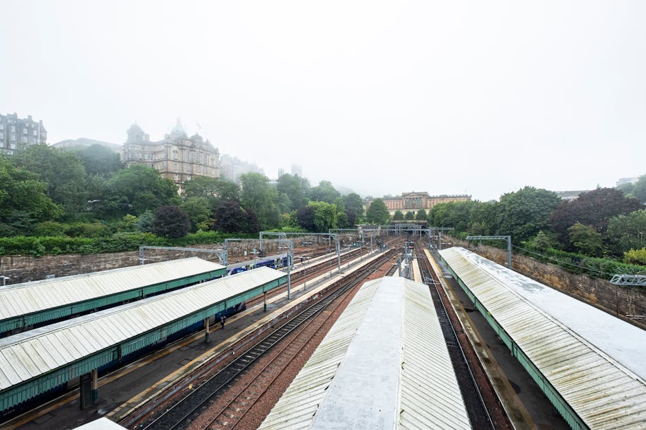 Misty morning view of train tracks and classic buildings in Edinburgh Scotland