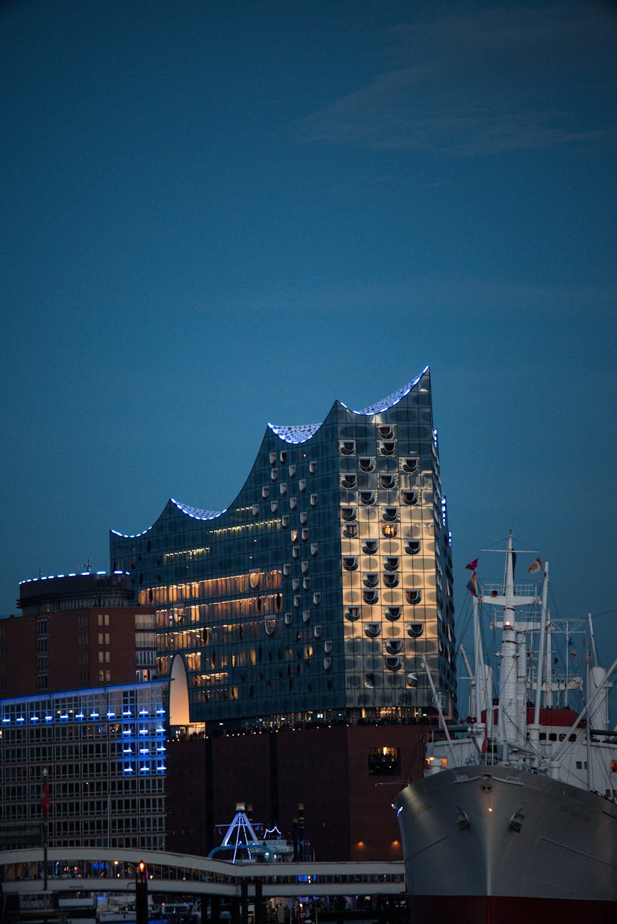 Elbphilharmonie concert hall illuminated against evening sky in Hamburg