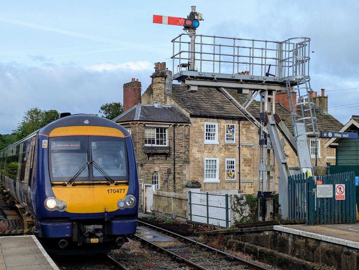 A train arriving at a charming English station platform