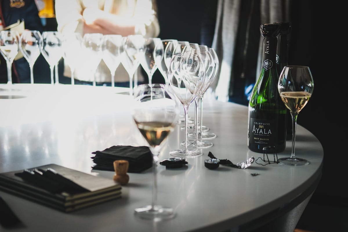 Champagne glasses and a bottle set on a table during a tasting session in Ay Champagne France