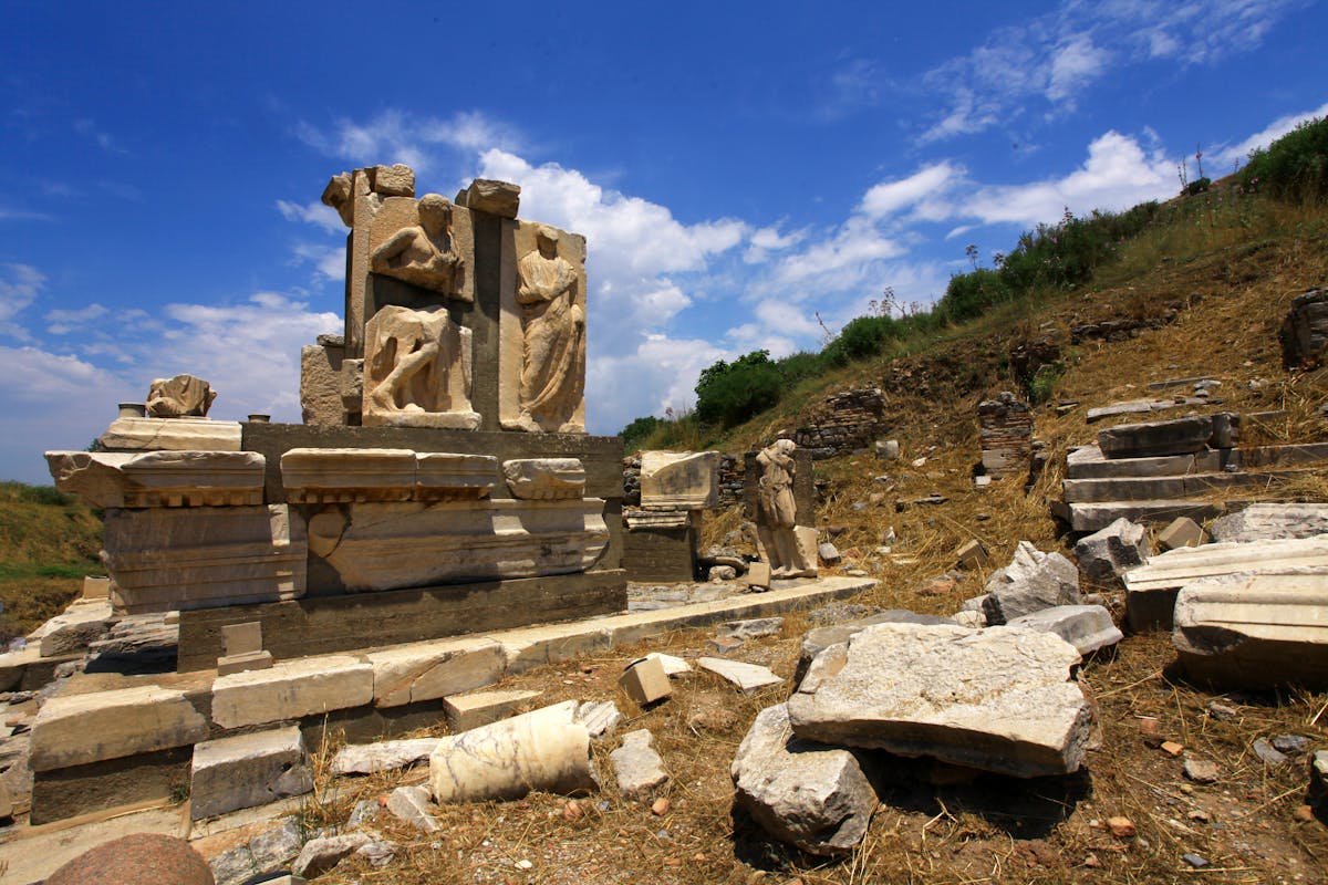 Ancient ruins at Ephesus under a bright blue sky with tall columns and stone pathways