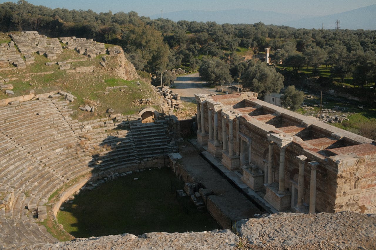 Wide view of the ancient theatre of Epidaurus set into the hillside surrounded by trees