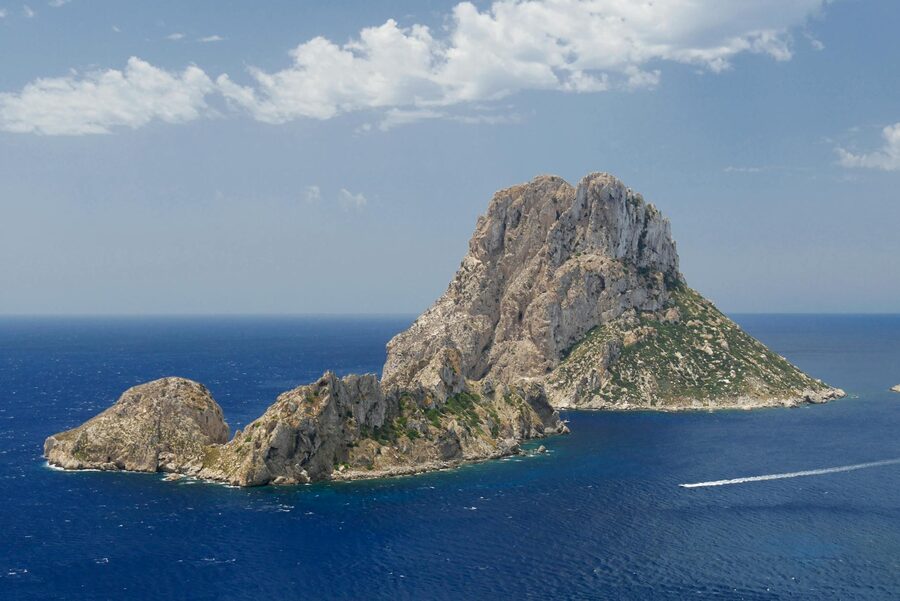 Aerial view of Es Vedra island surrounded by Mediterranean Sea under clear blue sky Ibiza
