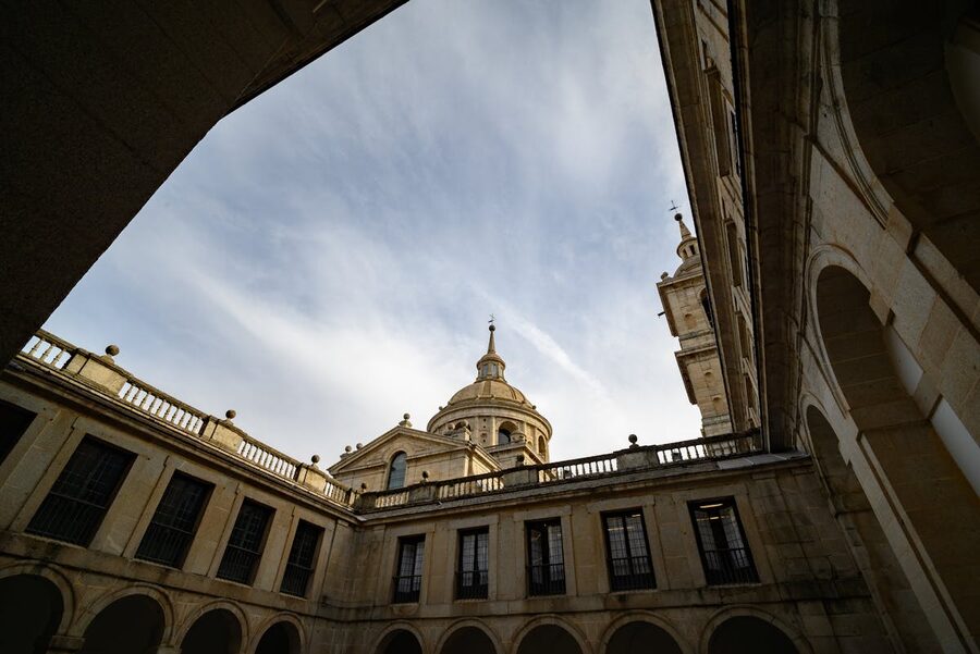 Interior courtyard of El Escorial monastery showing symmetric architecture and stone columns
