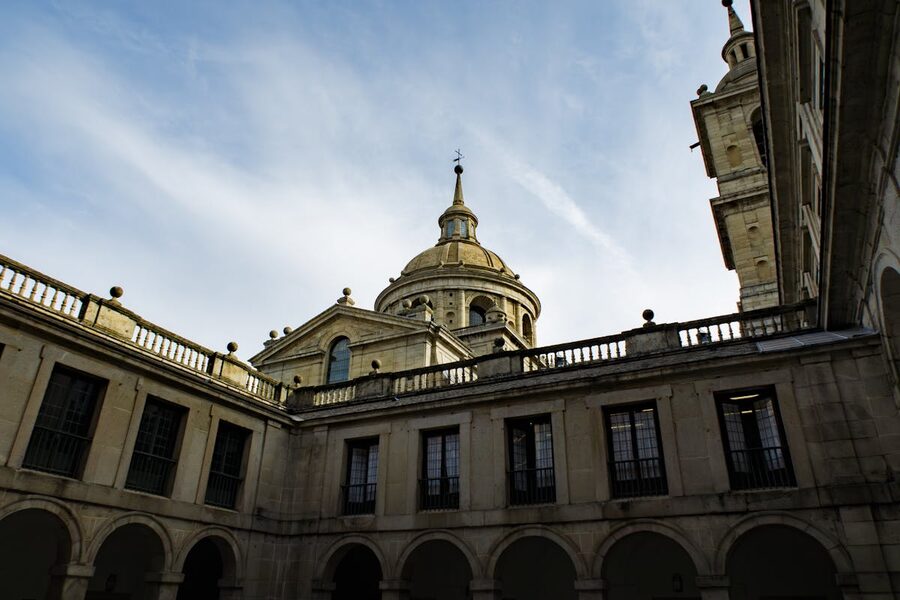 El Escorial monastery dome architecture against a clear Spanish sky