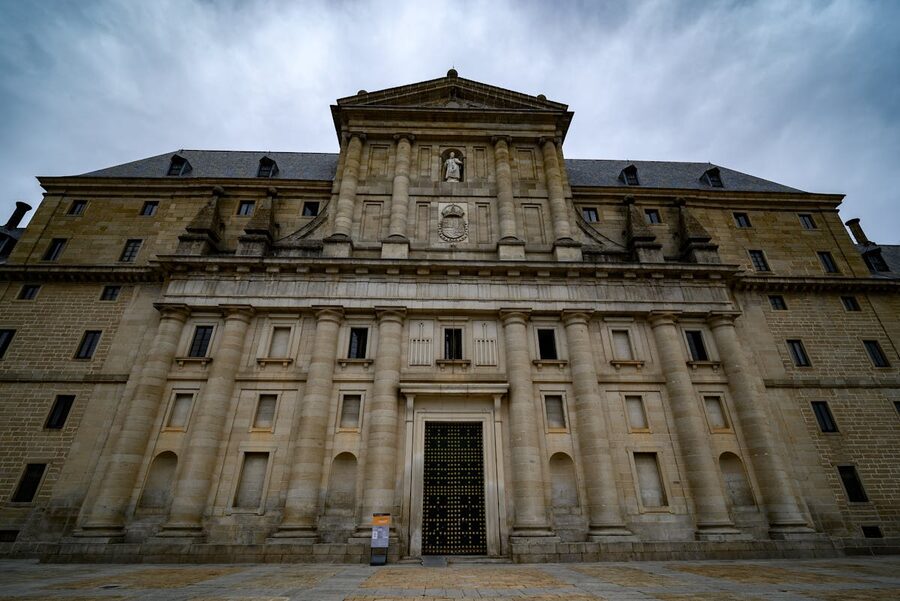 Close-up of El Escorial monastery facade showing granite stonework and architectural details