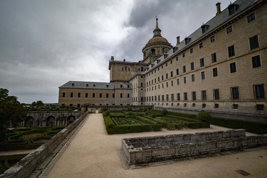 El Escorial monastery viewed from its formal gardens with manicured hedges