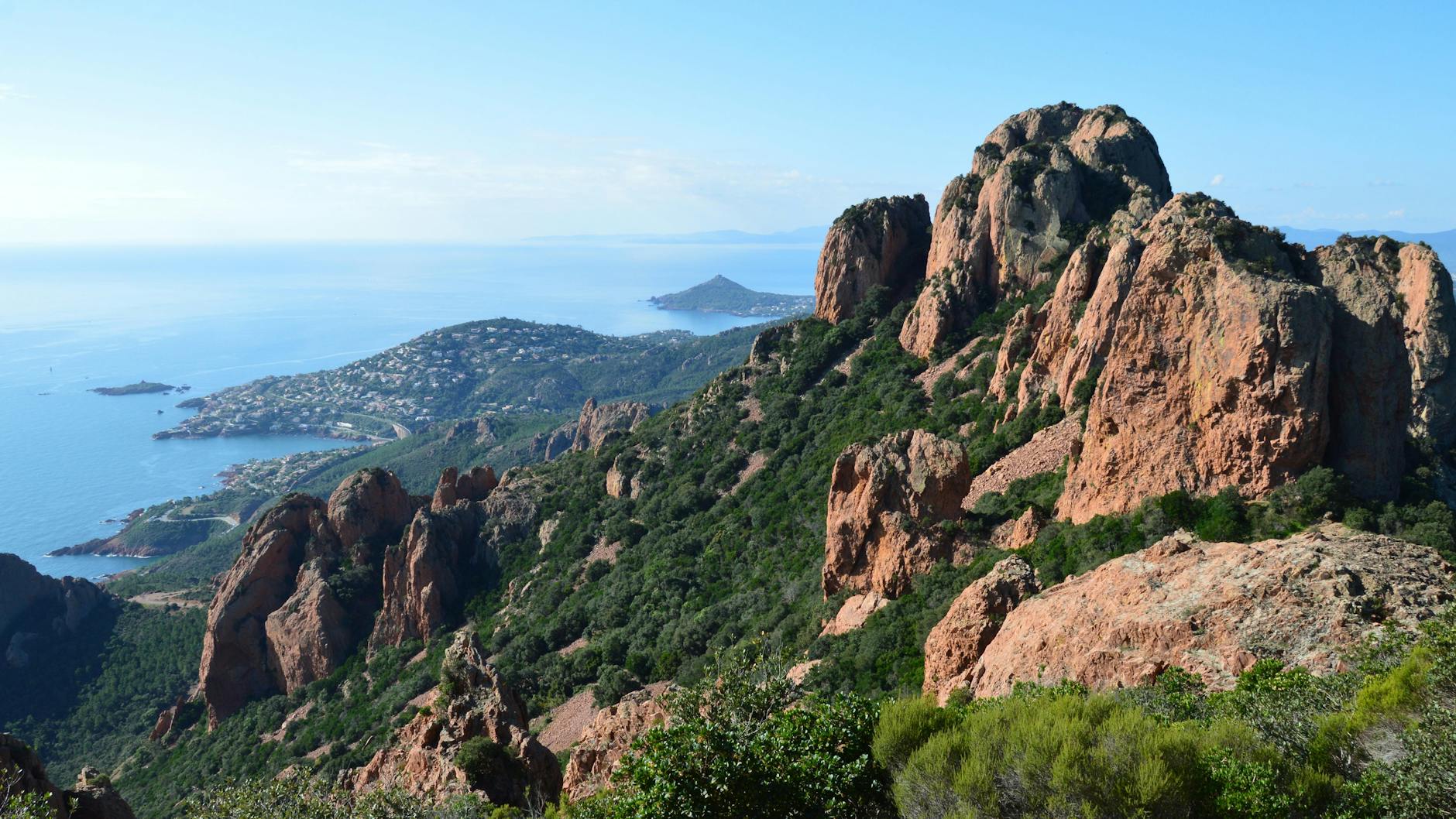 Dramatic red and green cliffs of the Esterel Massif seen from the Mediterranean