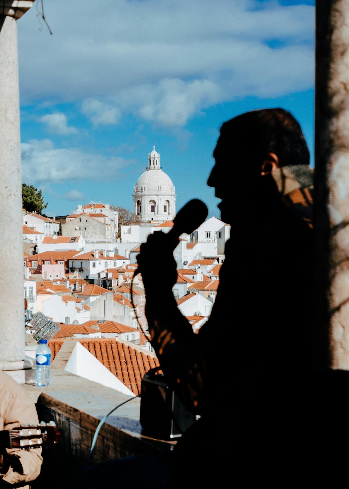 A fado singer performing in a dimly lit Lisbon venue