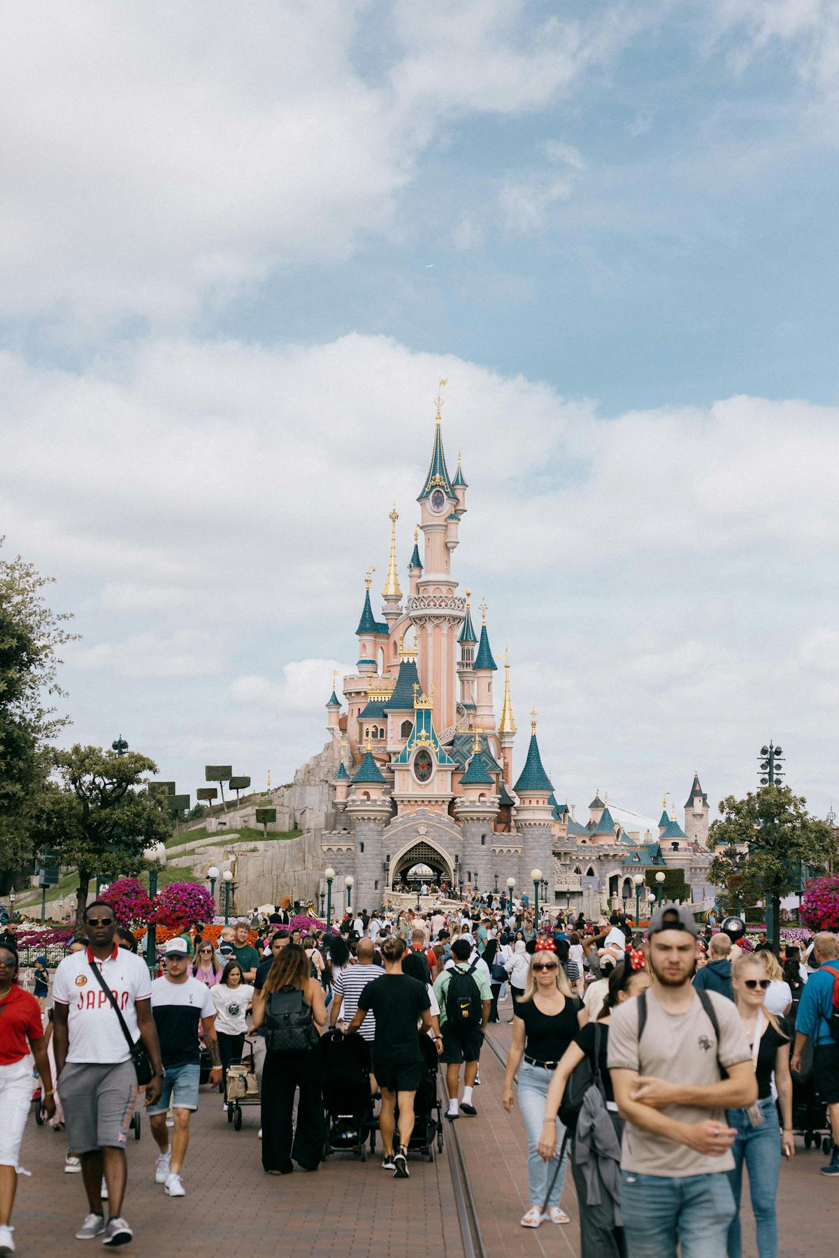 Families enjoying a day at Disneyland Paris with the castle visible in the background