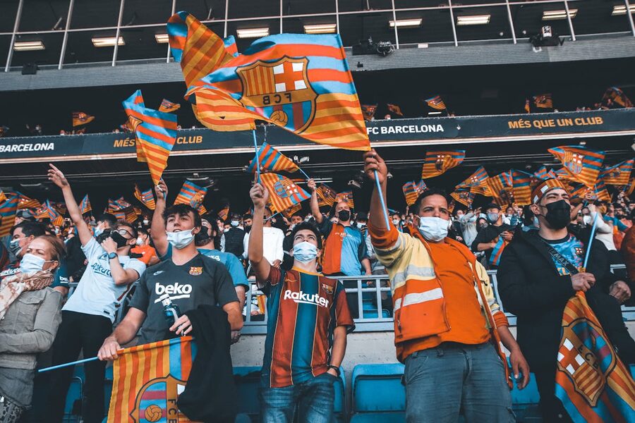 FC Barcelona fans waving flags at a football match