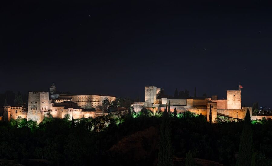 Illuminated Alhambra palace at night in Granada, Spain