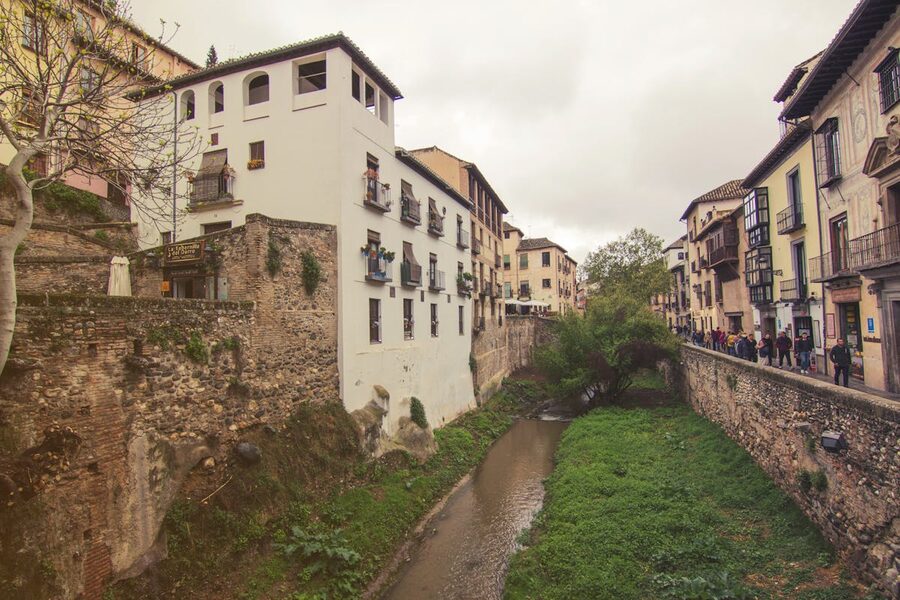 Picturesque street view of Granada architecture alongside the Darro river