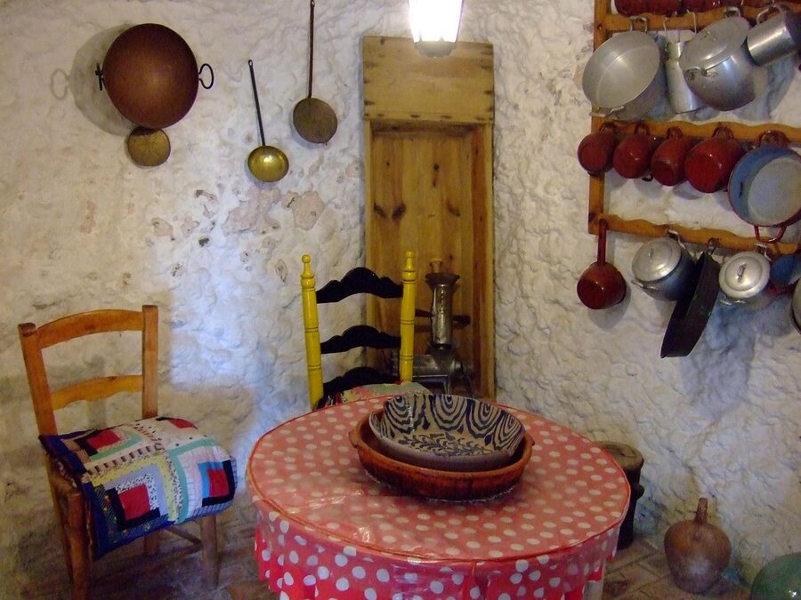 Interior of a traditional Sacromonte cave dwelling in Granada with whitewashed walls and rustic furnishings