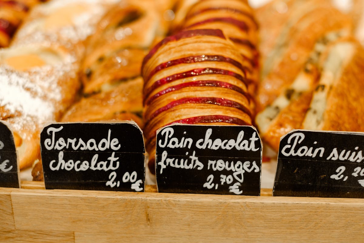 French pastries with visible price tags displayed in a bakery counter