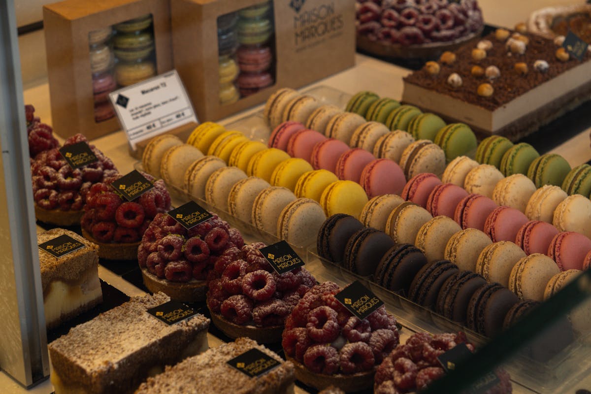 Colourful array of macarons and French pastries displayed at a patisserie