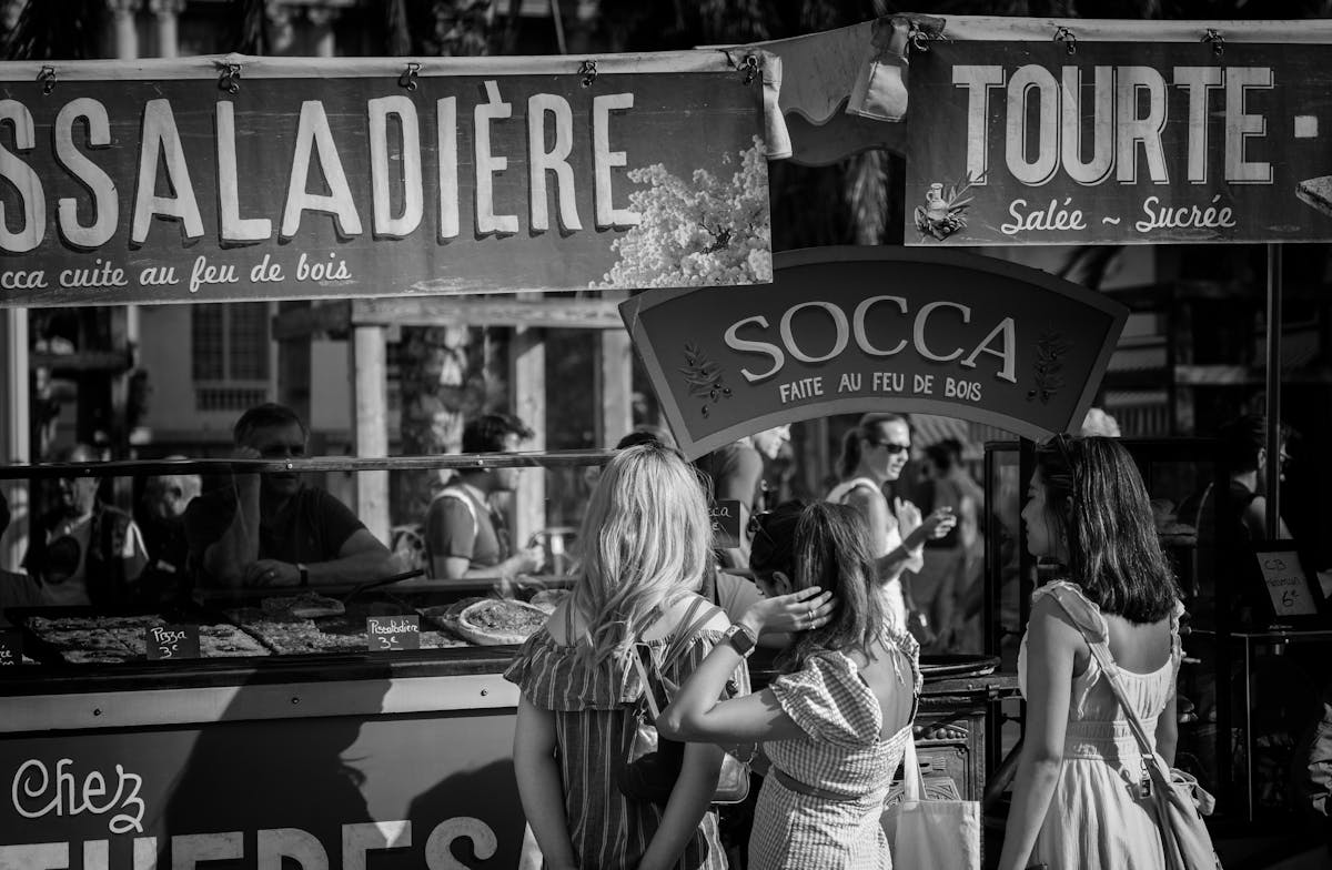 People browsing food stalls at the Cours Saleya market in Nice France