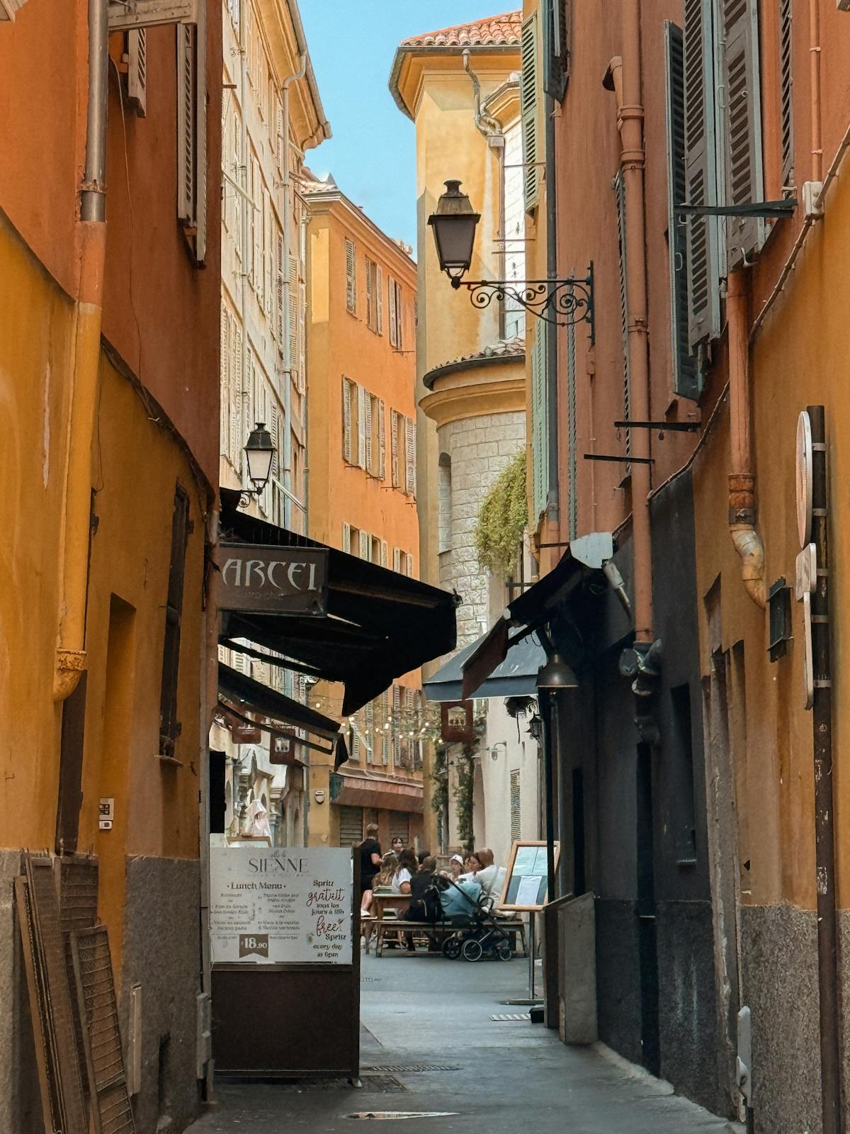 Narrow pedestrian street with colourful buildings in the old town of Nice France
