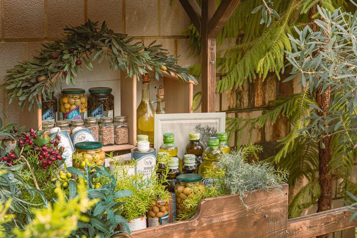 Display of olive oils and herbs at an outdoor market in southern France