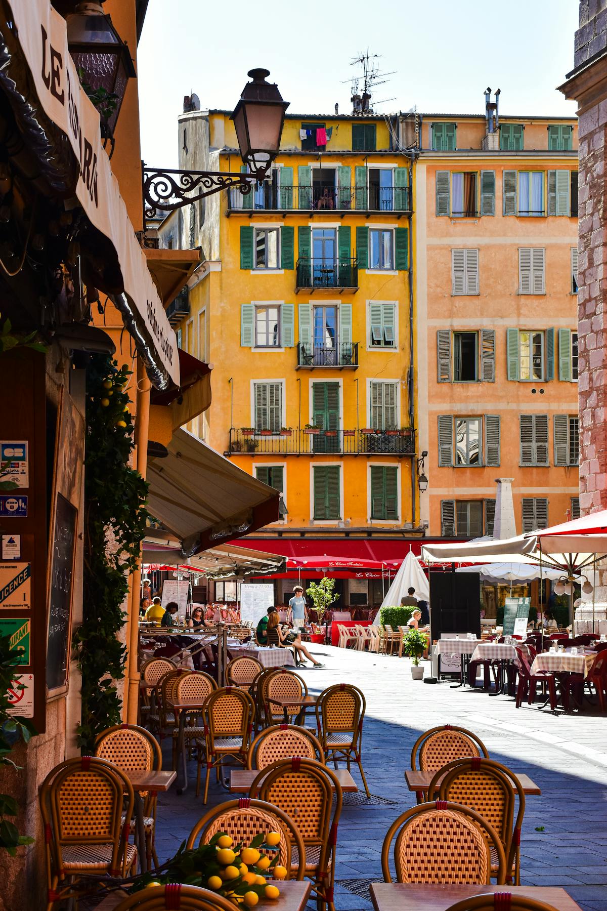Colourful street with outdoor cafe seating in Nice old town on the French Riviera