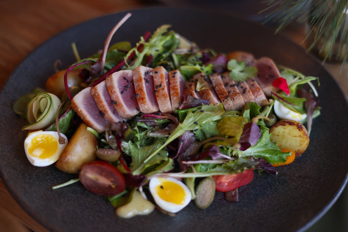 Gourmet salad with seared tuna, boiled eggs and fresh vegetables