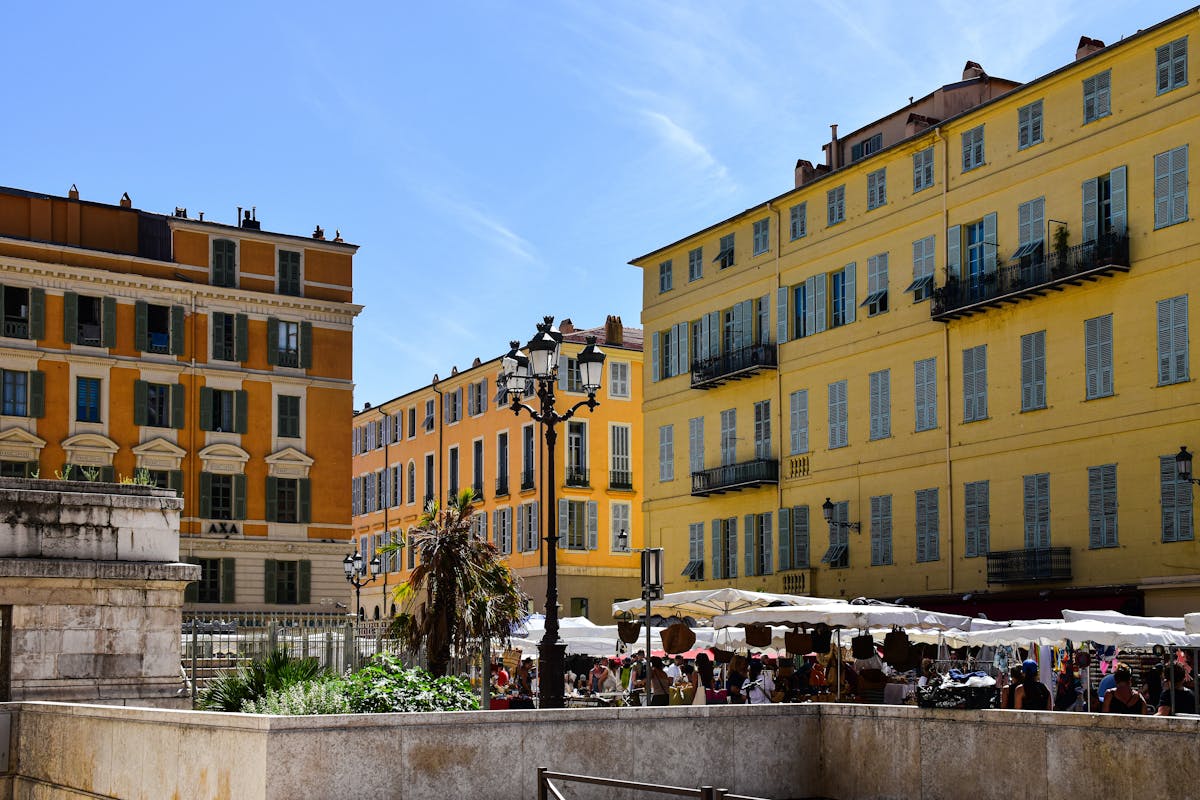 Yellow ochre facades of traditional buildings in Nice old town on a sunny day