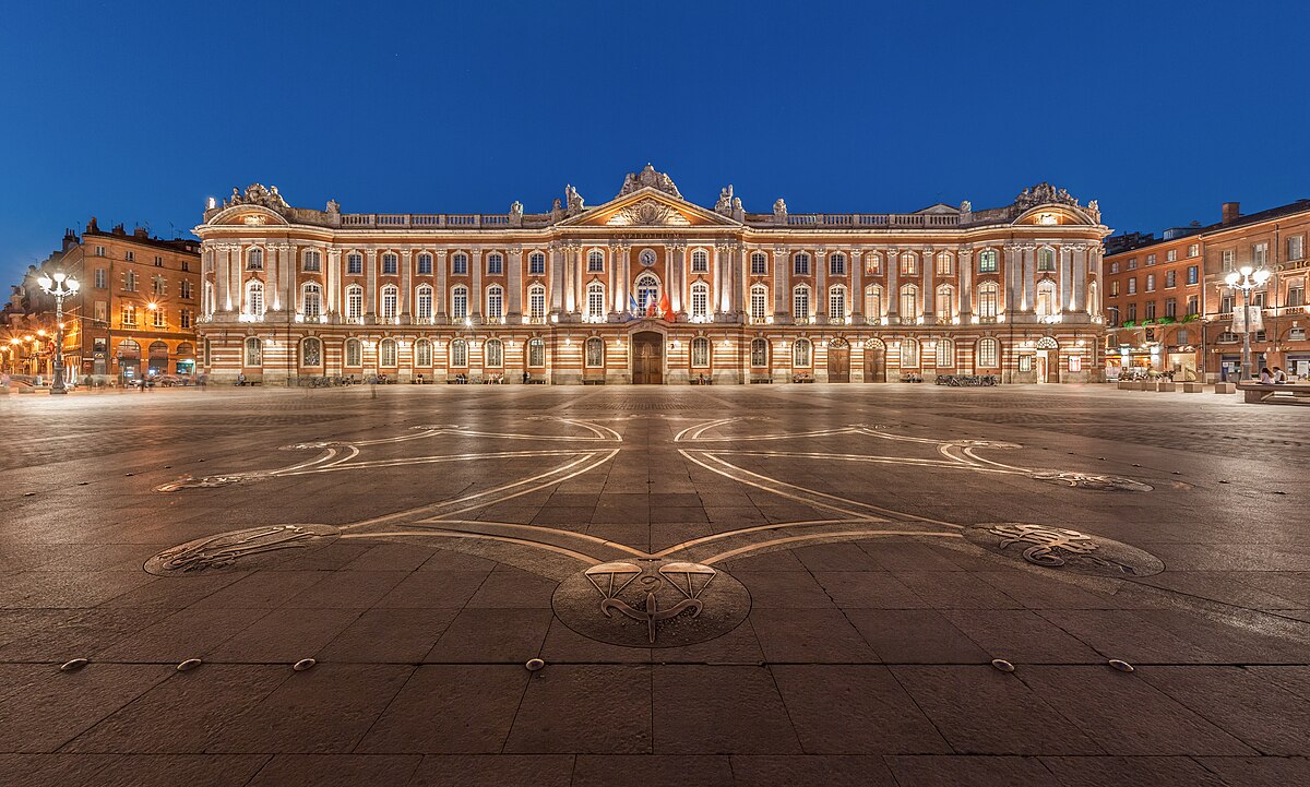 The Capitole de Toulouse lit up at night with dramatic lighting