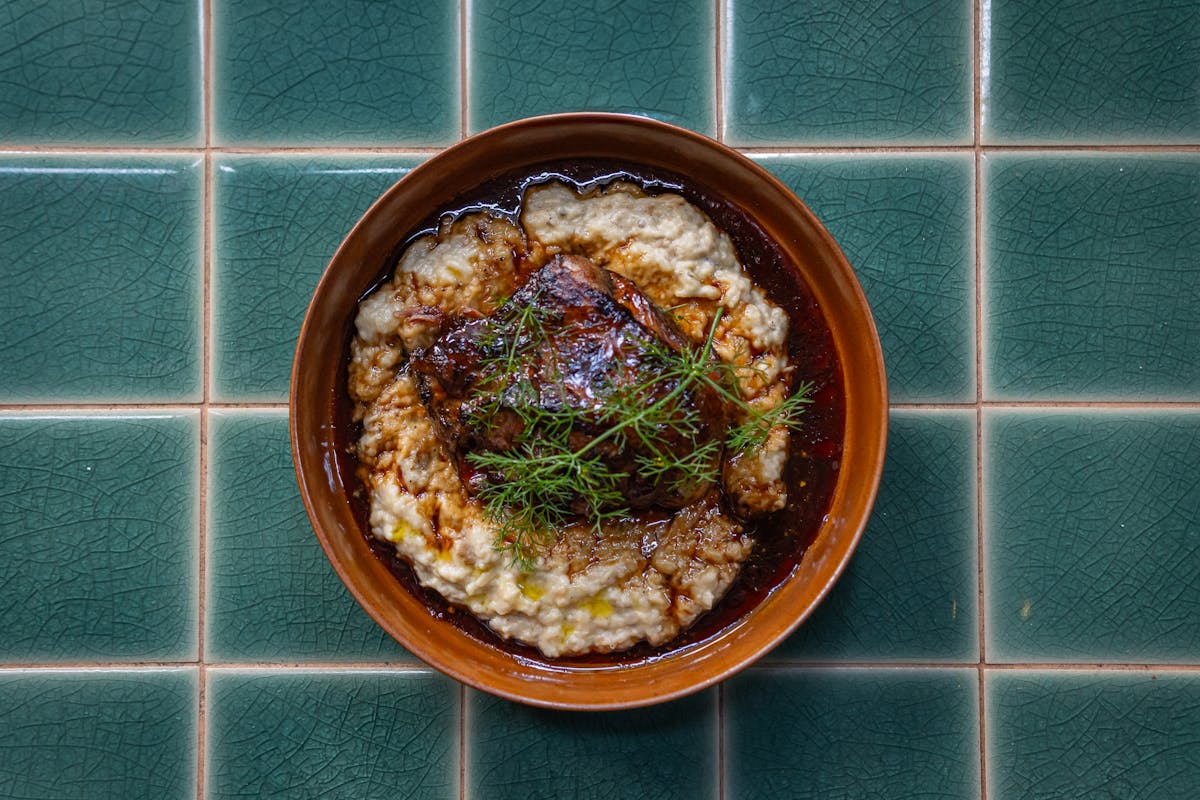 Traditional French slow-cooked dish served with creamy mashed potatoes