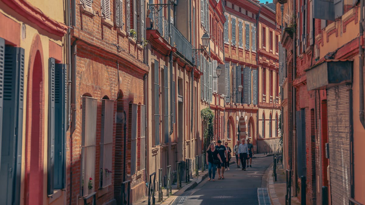 Pedestrian street in Toulouse historic centre with pink brick architecture