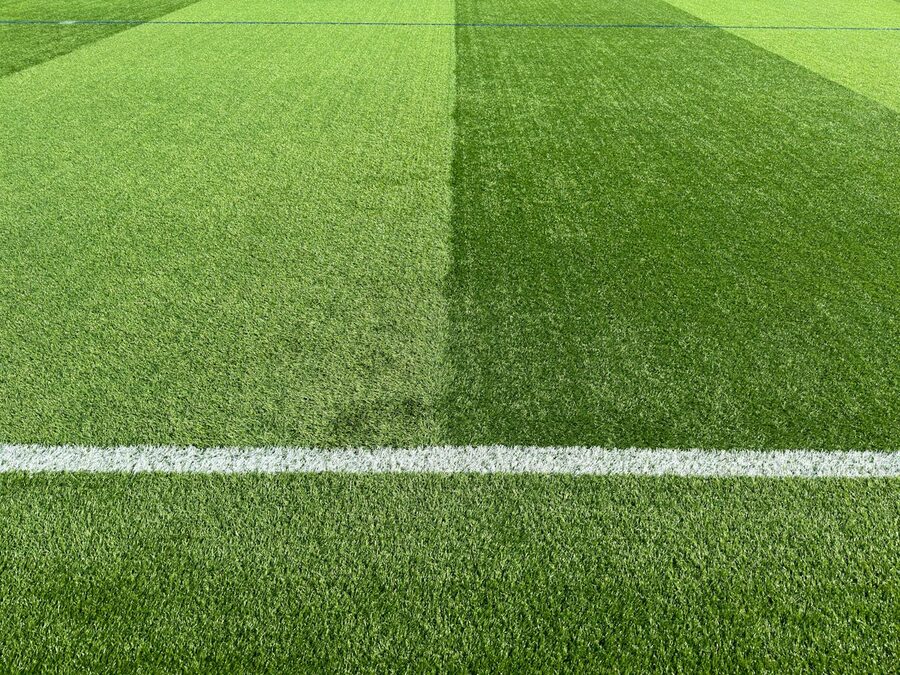 Close-up of white line markings on a green football pitch