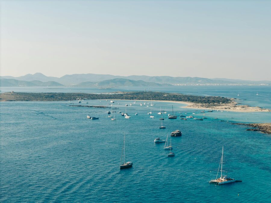 Sailboats and yachts anchored in turquoise waters near Formentera island Balearic Islands