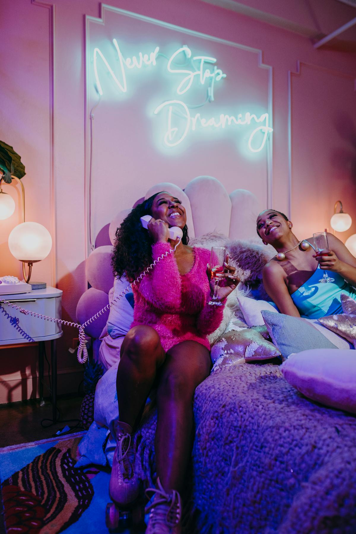 Women enjoying a cozy night with neon lights and laughter