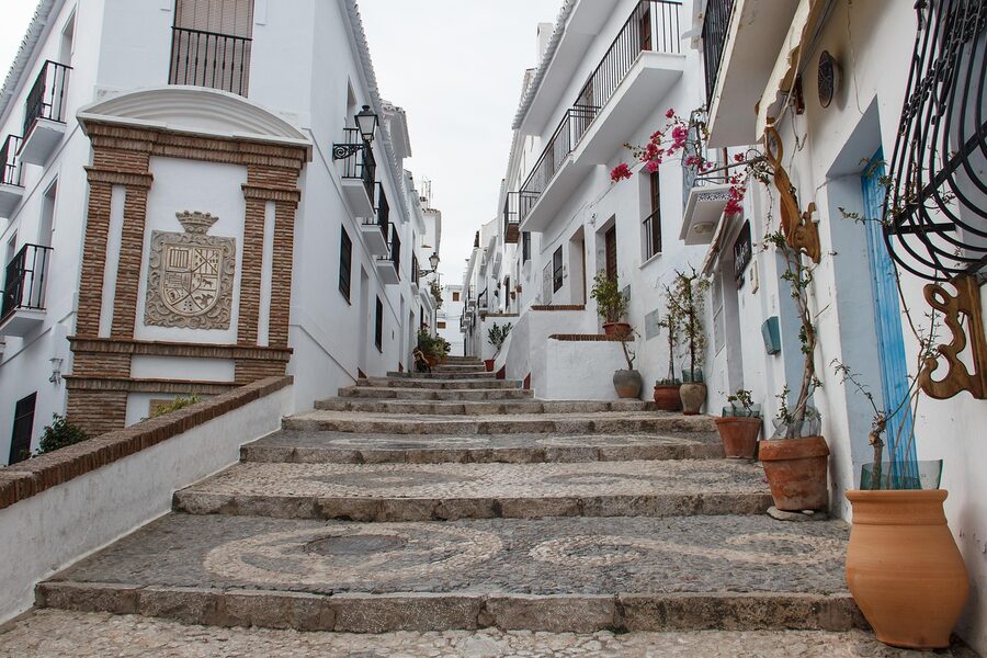 Panoramic view of the white village of Frigiliana with Mediterranean coast visible in the distance