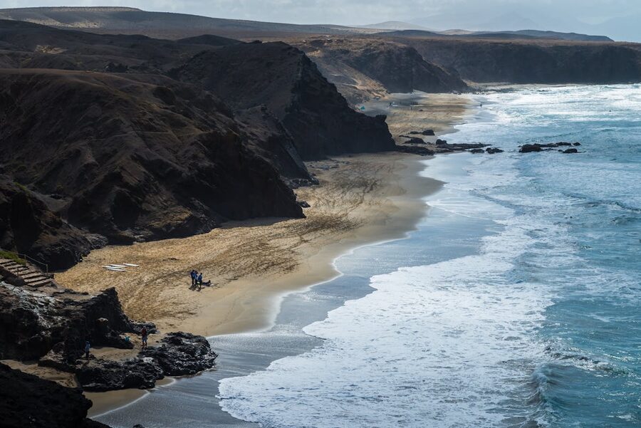 Aerial view of Playa del Viejo Reyes with cliffs and crashing waves in Fuerteventura