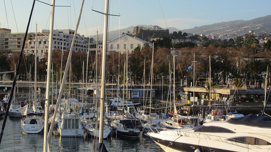 Marina do Funchal harbour with boats and seafront promenade
